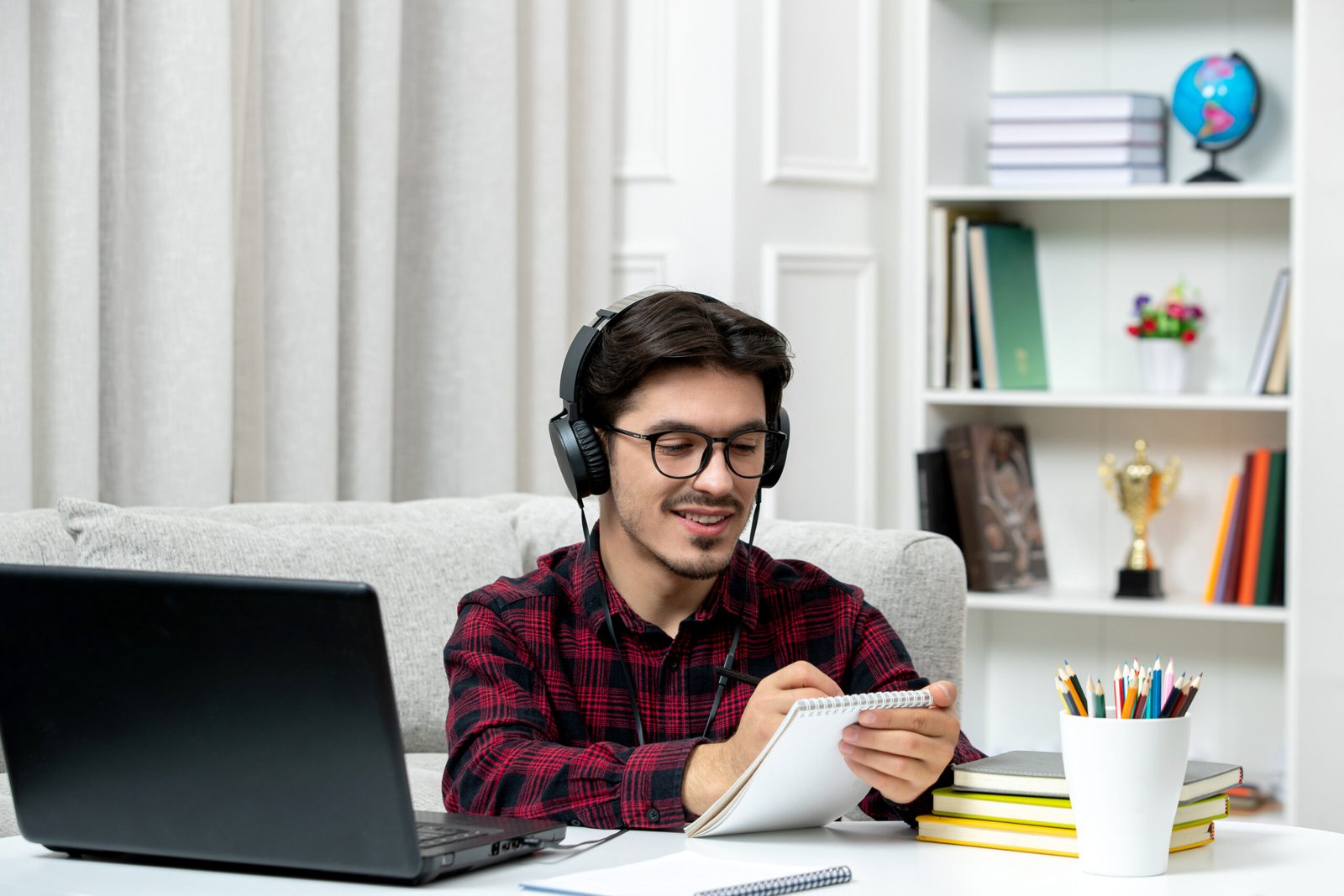 student-online-cute-guy-checked-shirt-with-glasses-studying-computer-writing-notes